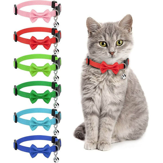 Gray cat wearing red adjustable collar with bow and bell, cat collars in pink, red, green, light green, blue, and dark blue