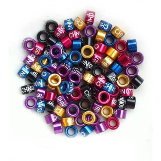 Colorful bird leg bands rings with numbers and letters on a white background